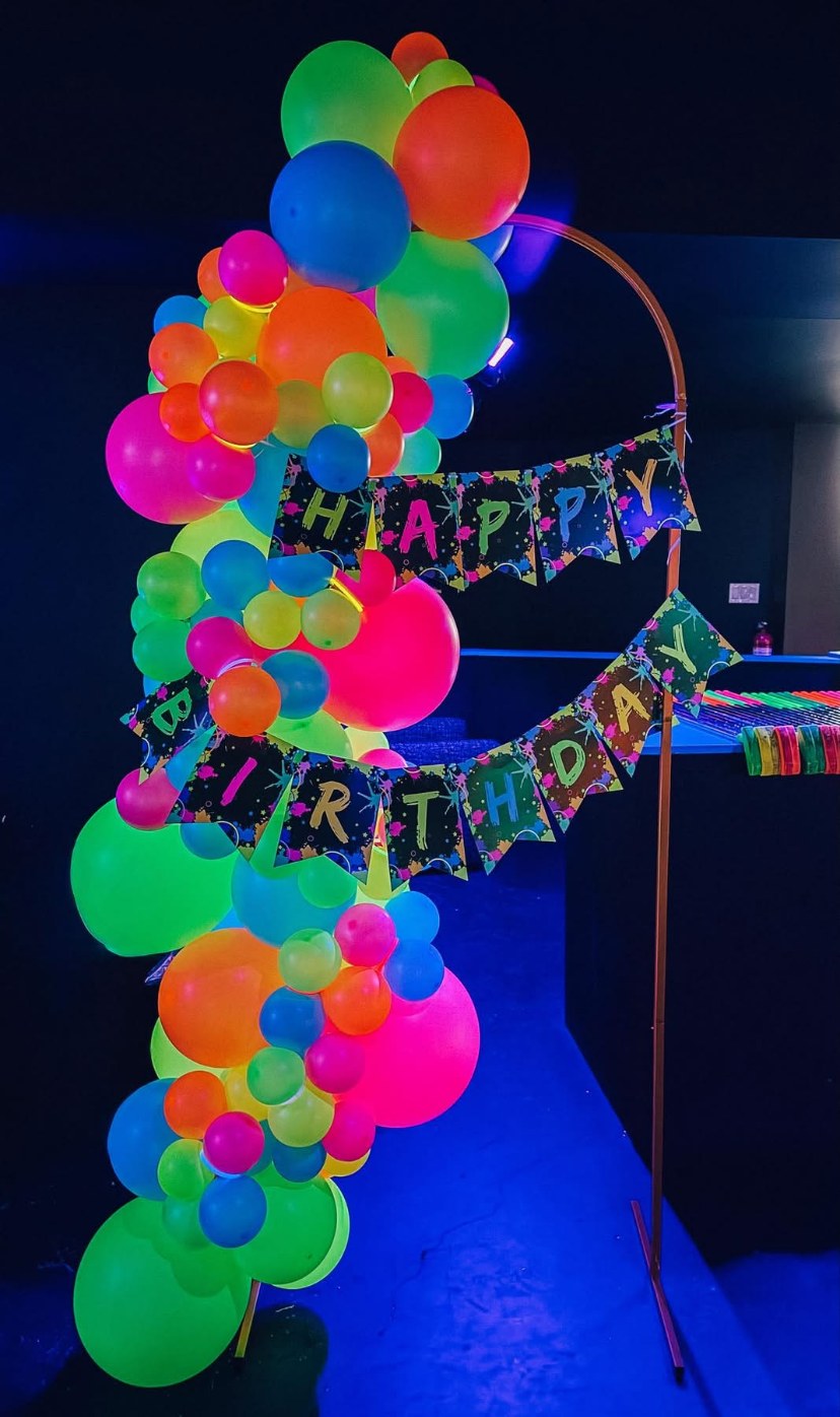 Neon birthday balloon garland on a hoop backdrop